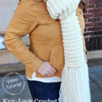 Woman with mustard yellow jacket wearing a cream colored knit look crochet scarf.