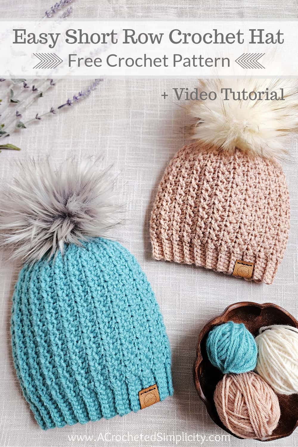 Two short row crochet hats laying with a wooden yarn bowl and small balls of yarn.