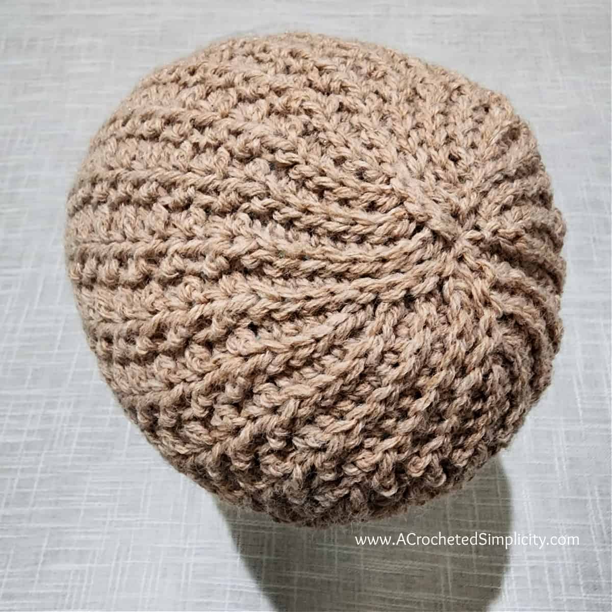 Top of a brown short row crochet hat showing the short row crown.