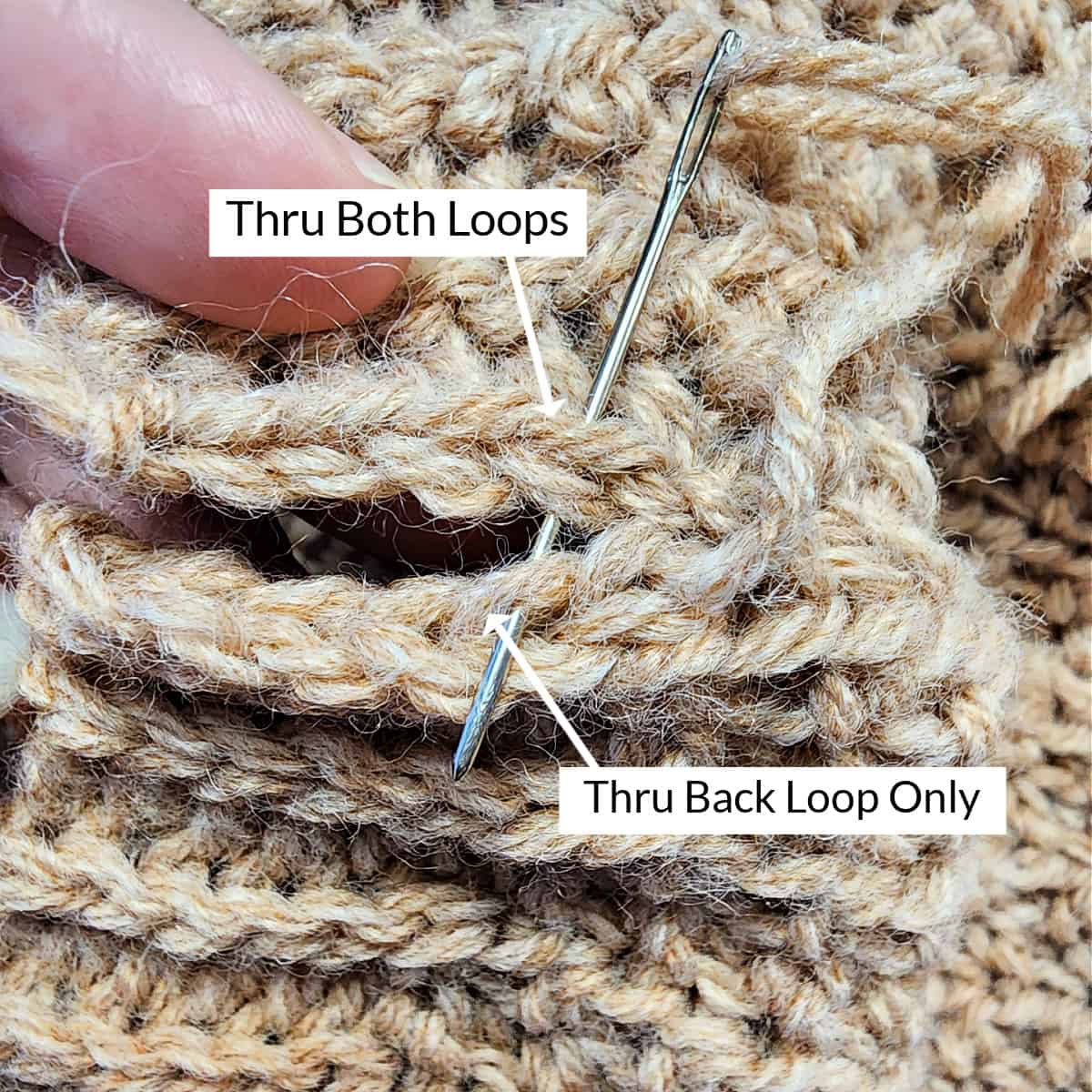 Yarn needle showing where to work the seam across the hat band portion of the crochet hat.