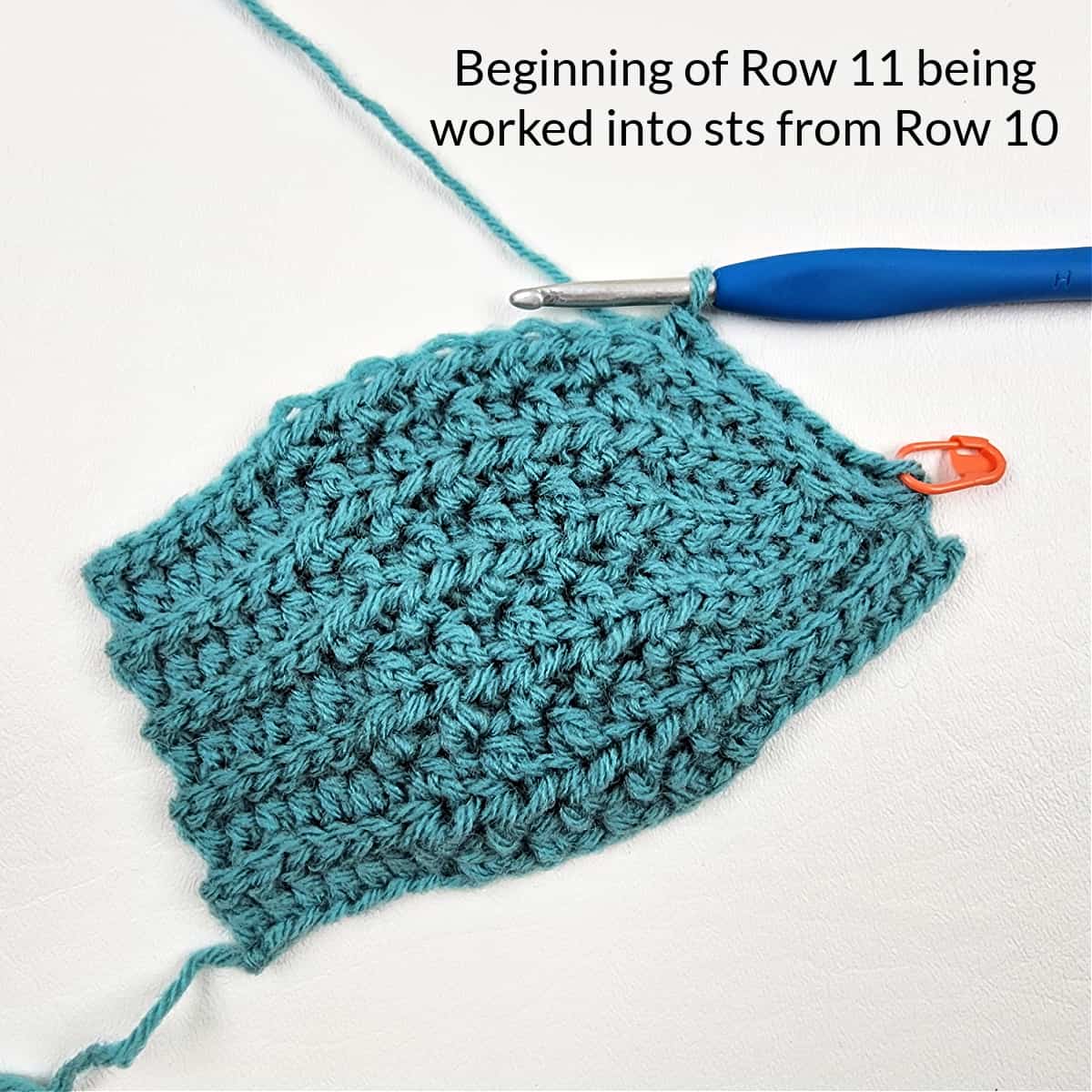 Begin the next crochet short row section on the green hat.