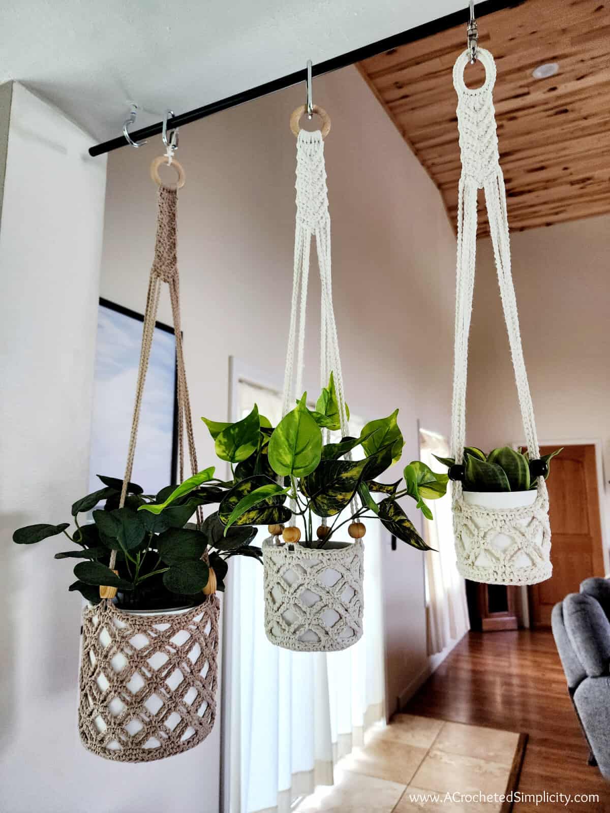 Three neutral colored crochet plant hangers with wooden beads.