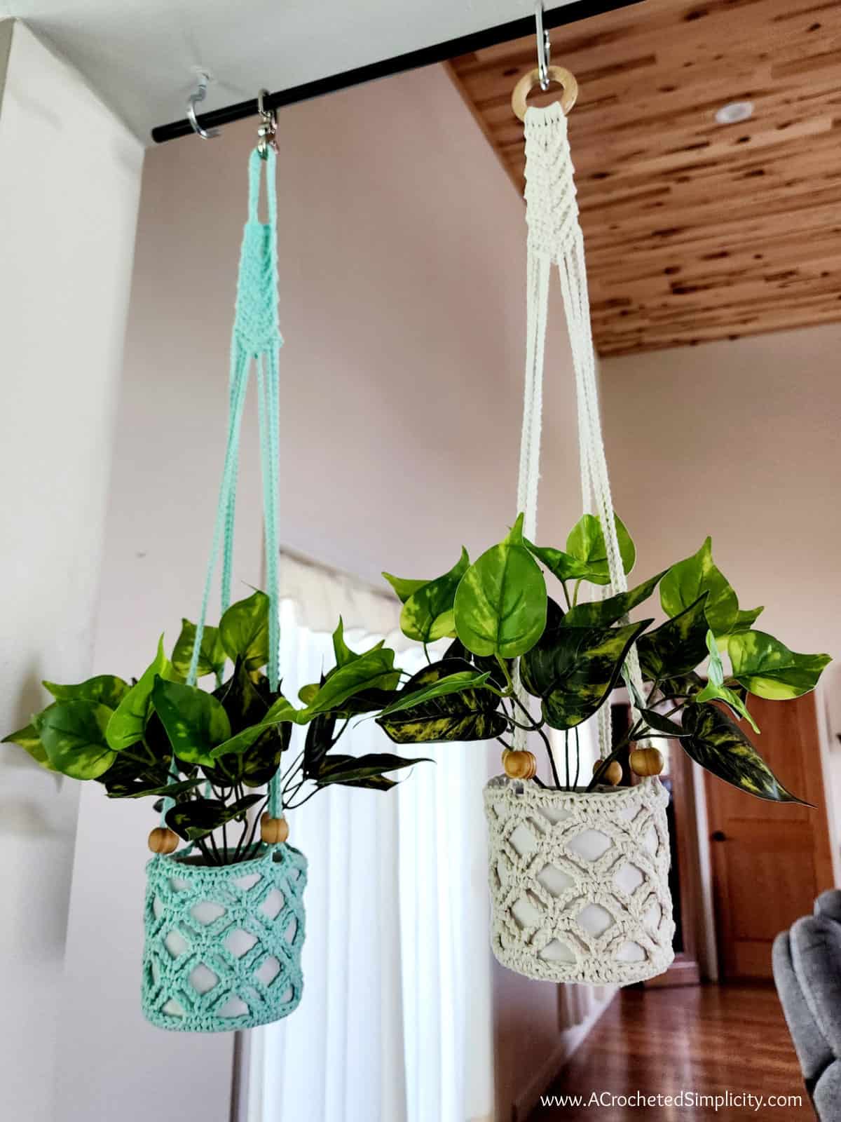 Two medium crochet plant hangers in ecru and sea glass cotton yarn.