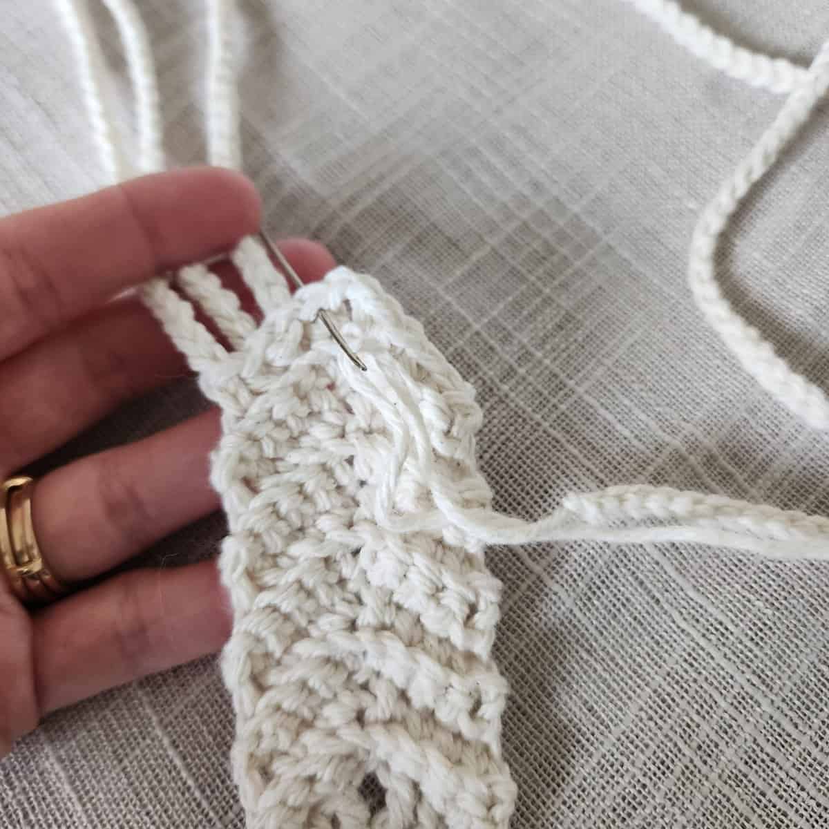 Crochet hanging straps being woven into hanging ring.