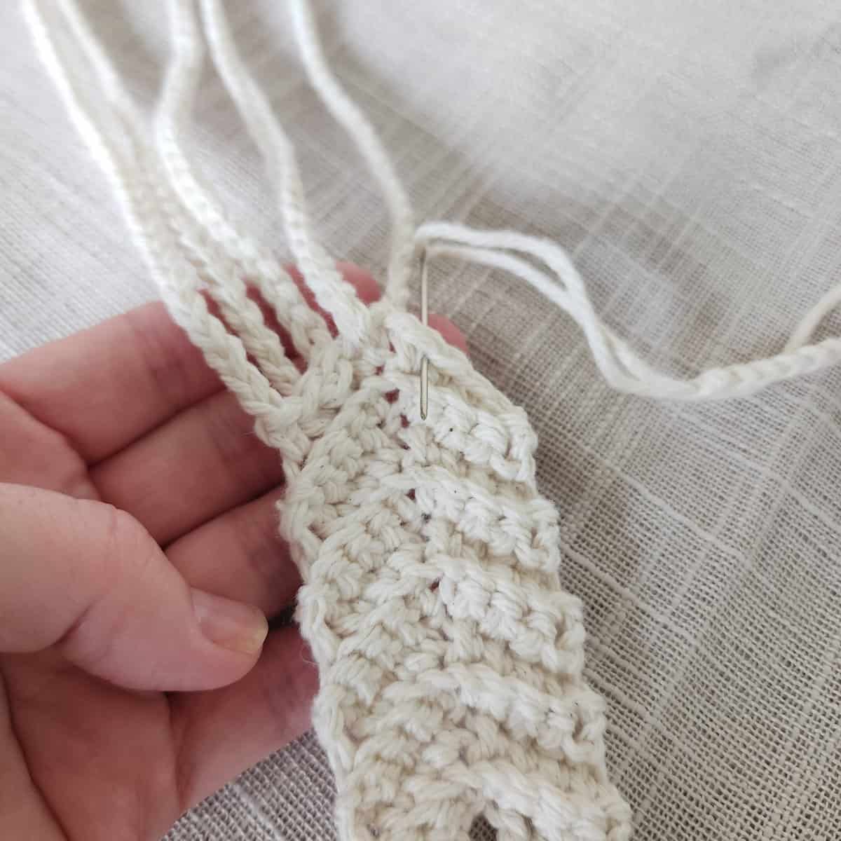 Three crochet hanging straps being attached to hanging ring.