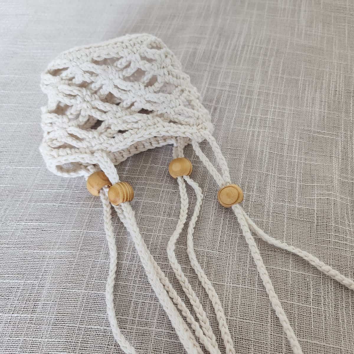 Close up of crochet plant hanger with wooden beads.