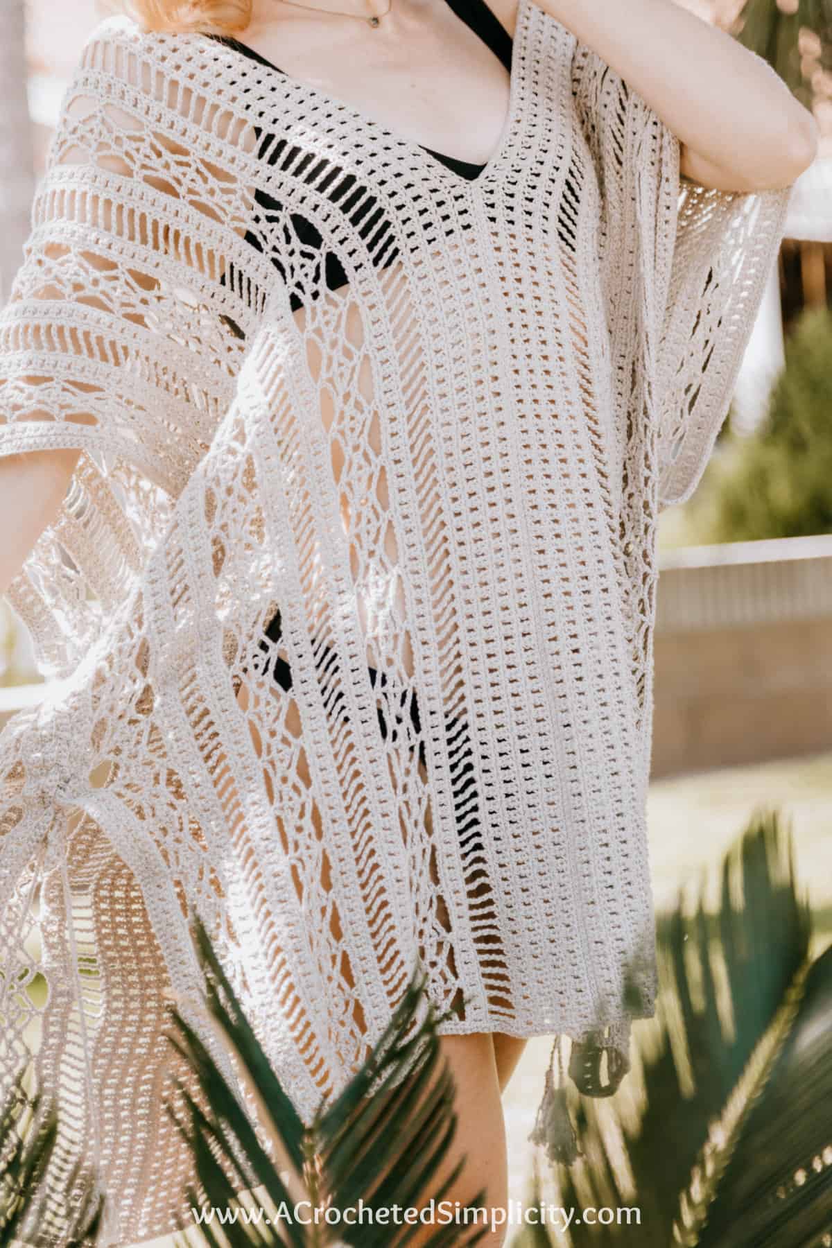 close up of model wearing a crochet swim cover up