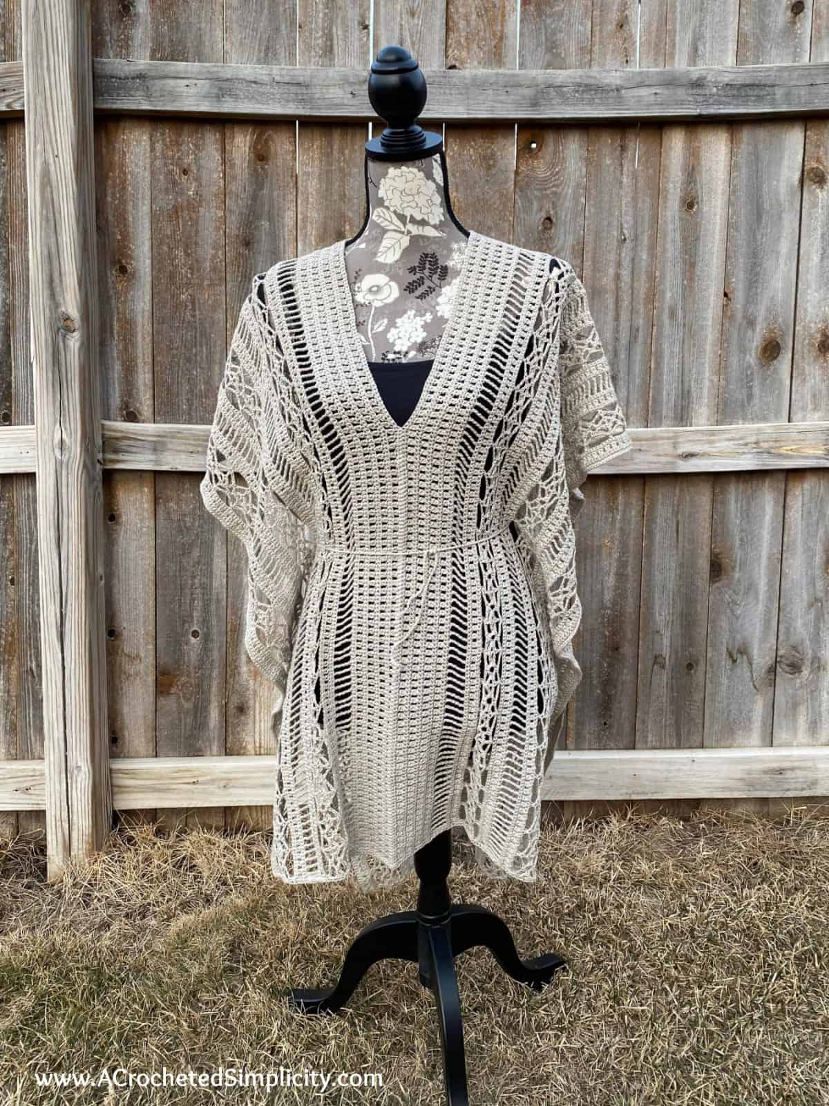 light tan crochet beach cover up on a mannequin