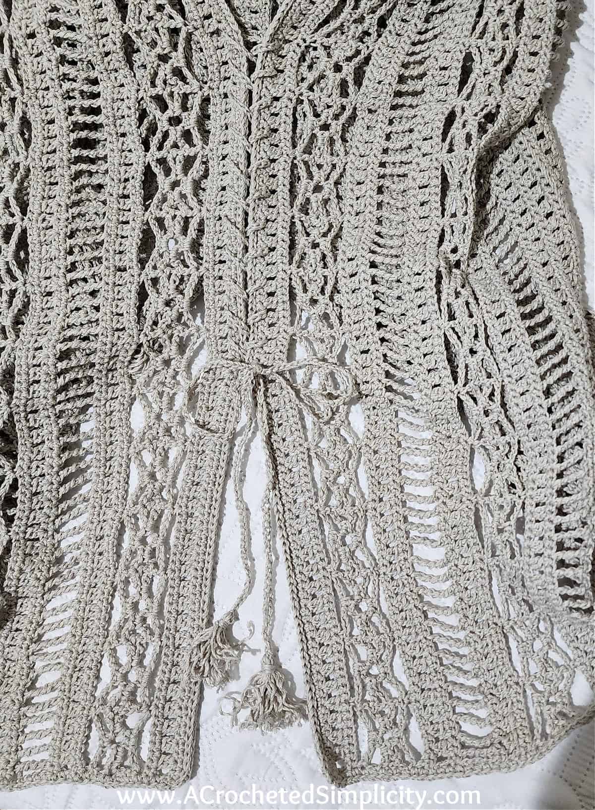 Close up showing the ties on the side of a swim cover up.