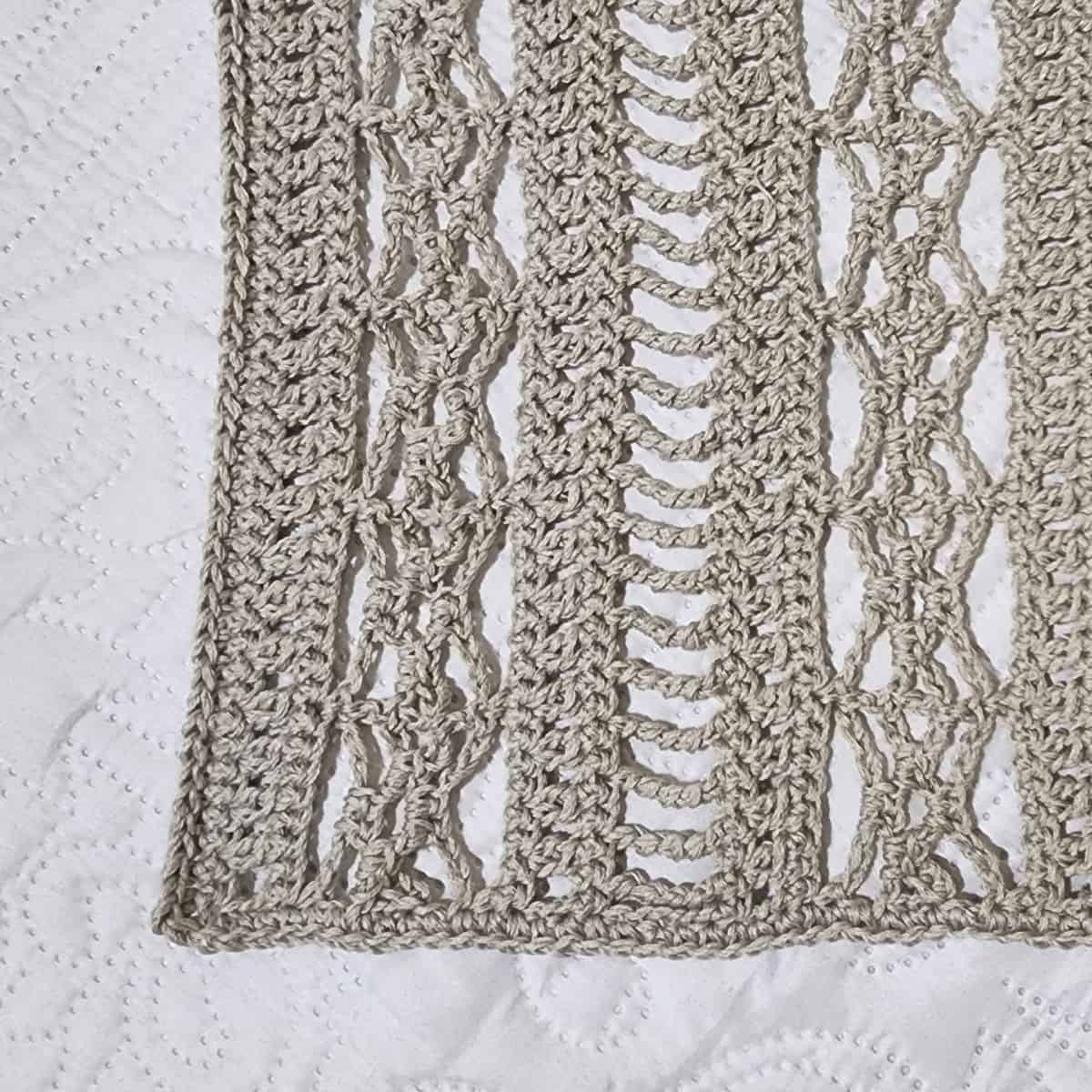 Close up of lace pattern on crochet swimsuit cover up.