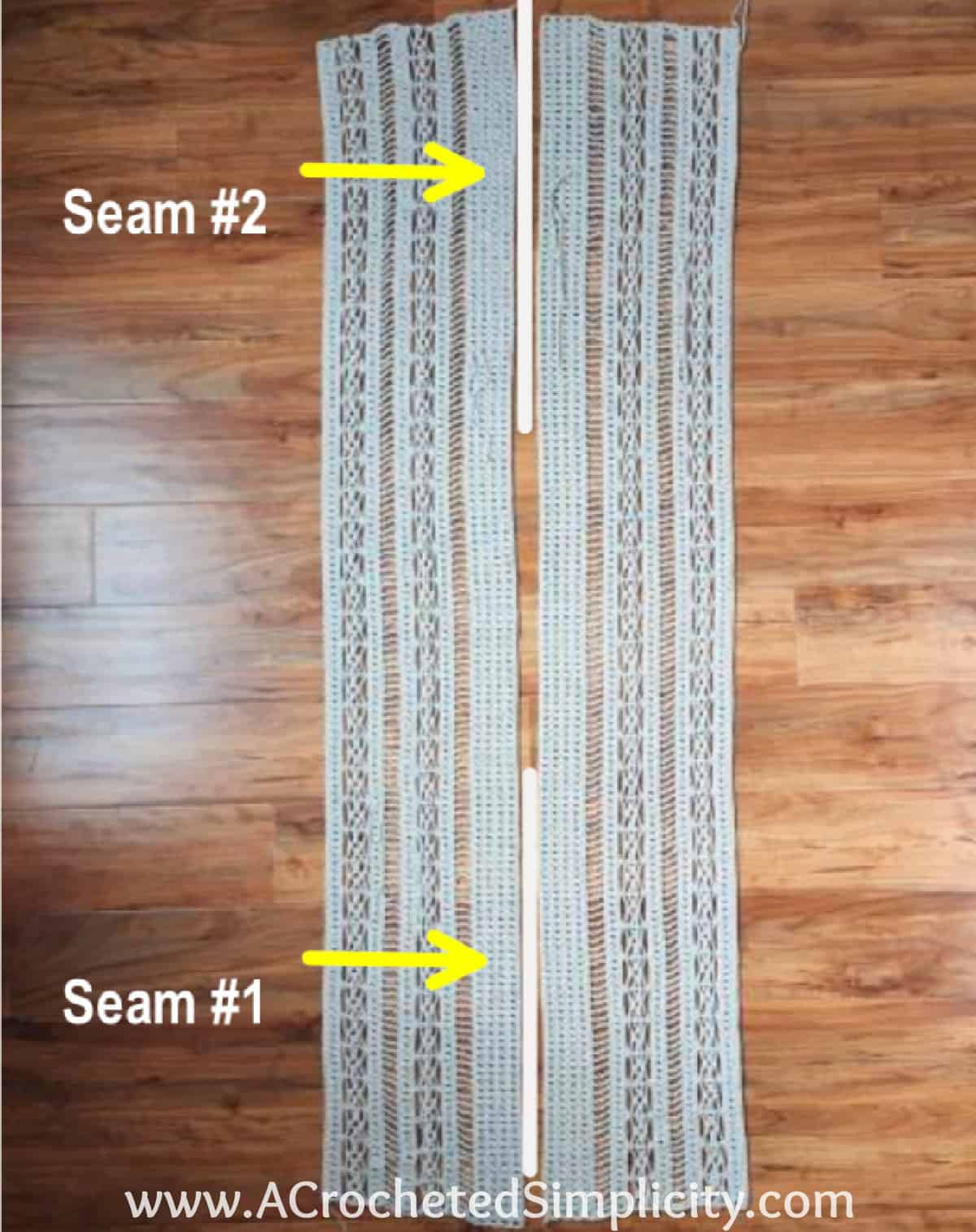 Two panels of a crochet swim cover up laid flat on wood floor to seam them.
