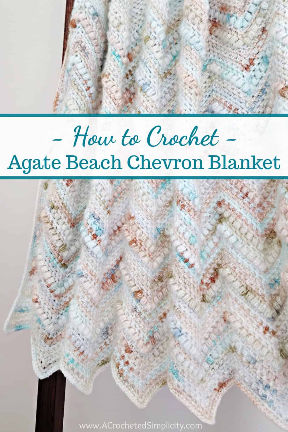 Crochet chevron blanket in the linen stitch with puff stitches and hanging on a blanket ladder.
