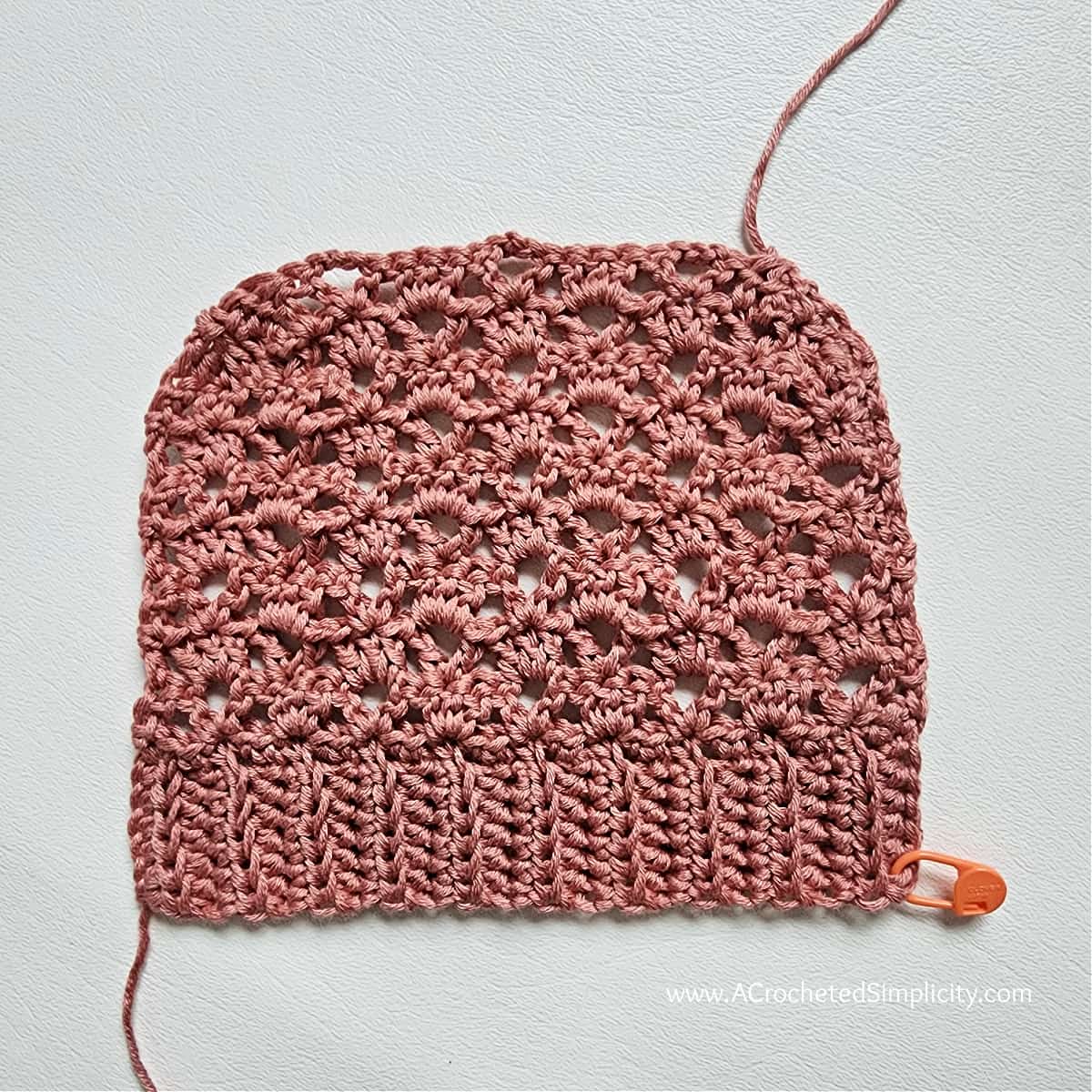Upside down lacey crochet pocket with ribbing.