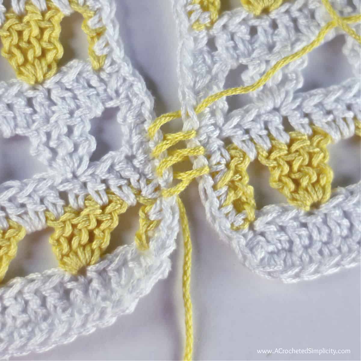 This photo shows the mattress stitch crochet seam after a few stitches are worked back and forth, before being pulled tight.
