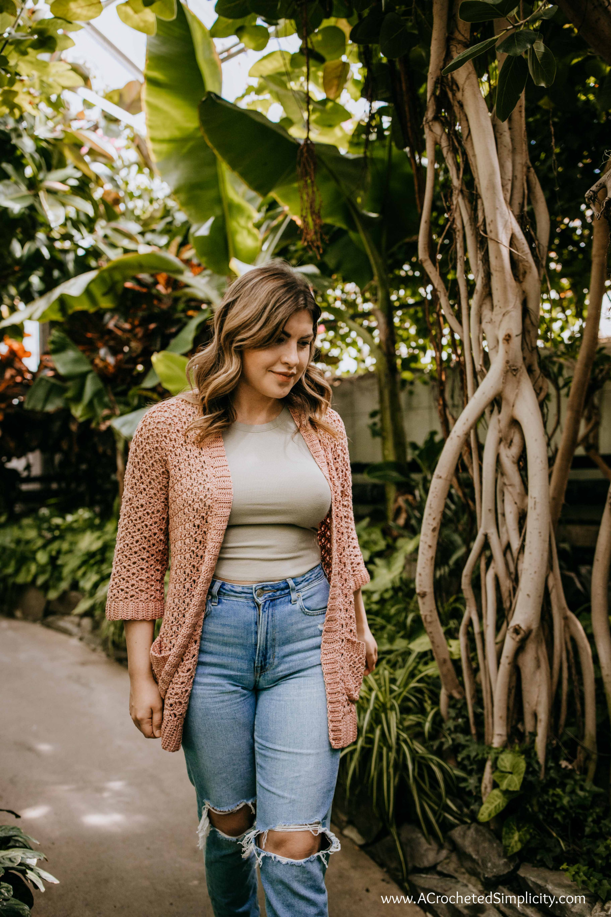 Woman wearing a crochet summer cardigan.