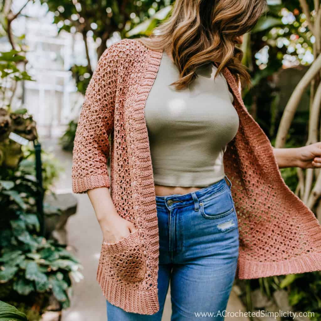 Woman wearing a crochet summer cardigan.