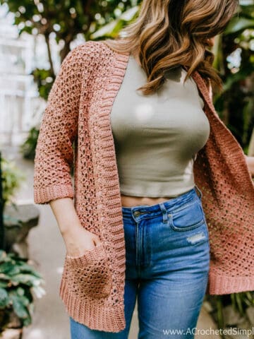 Woman wearing a crochet summer cardigan.