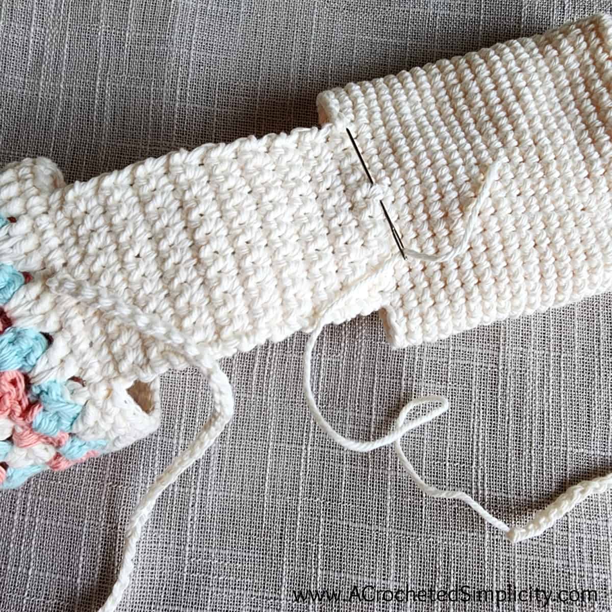 Crochet ties being attached to the back of a chair caddy.