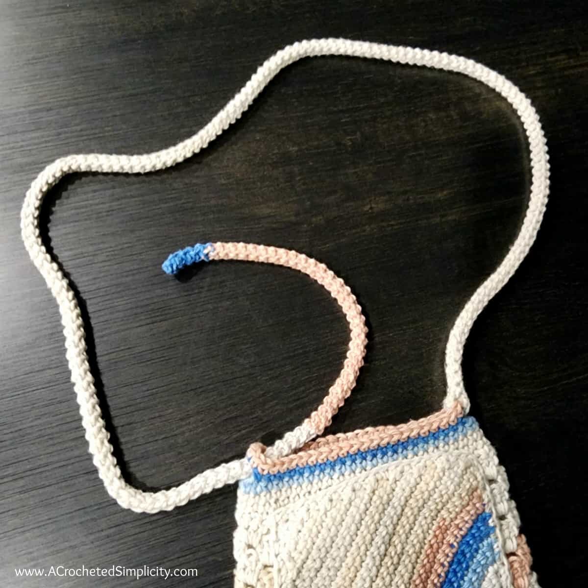 Photo tutorial showing how to assemble the water bottle sling strap.