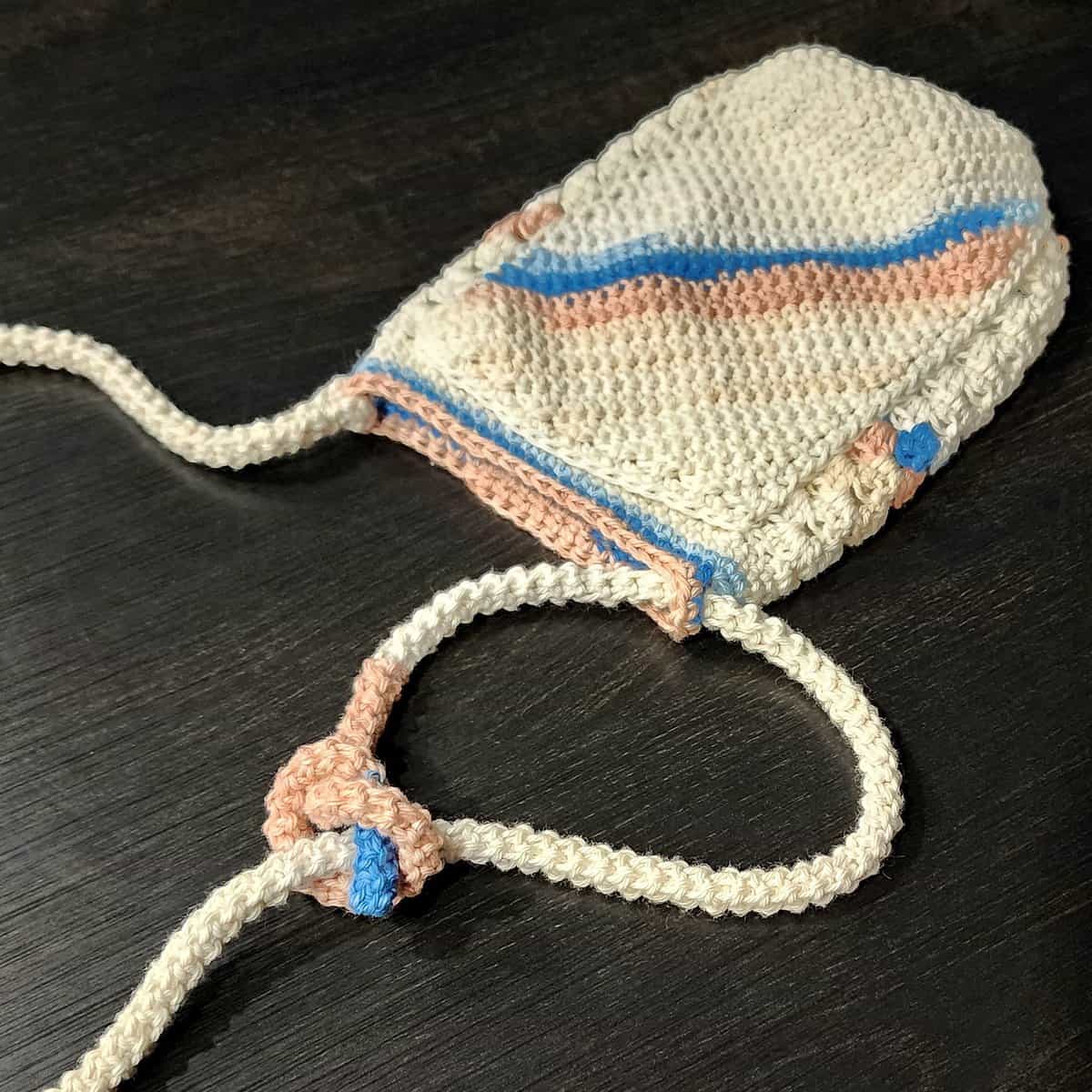 Photo tutorial showing how to knot the crochet rope to make the strap adjustable.