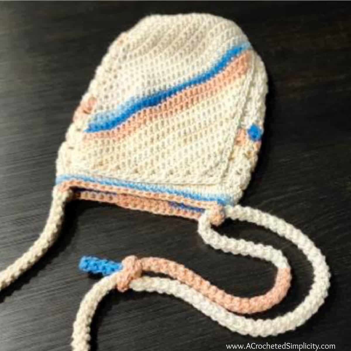 Tutorial photo showing how to secure the sliding knot for the crochet adjustable strap.