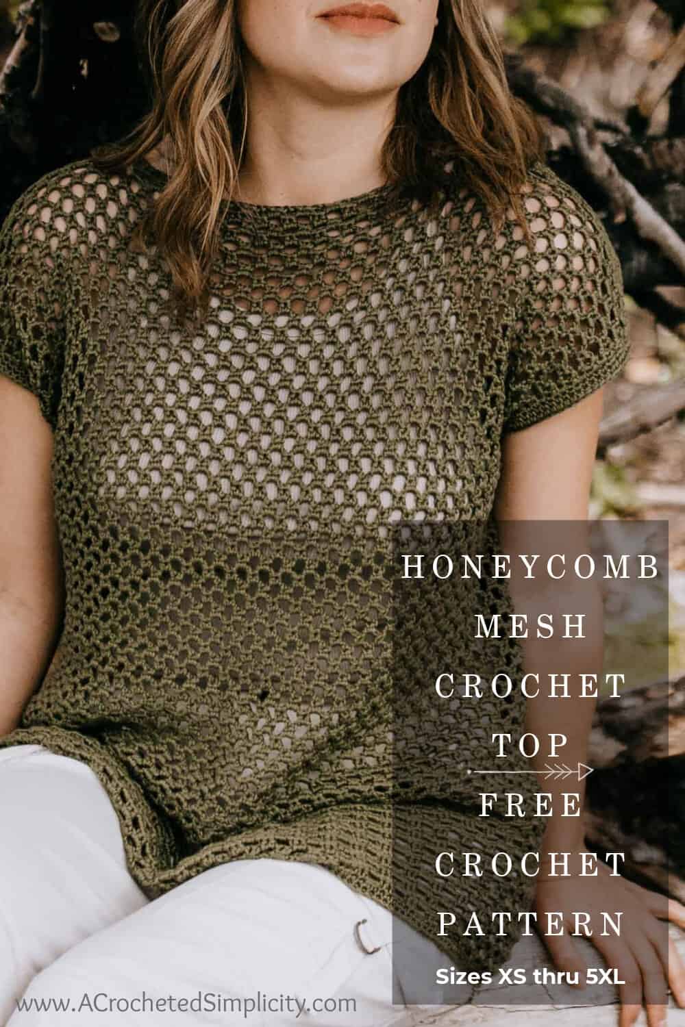 Woman sitting on driftwood modeling a mesh crochet top in olive green.