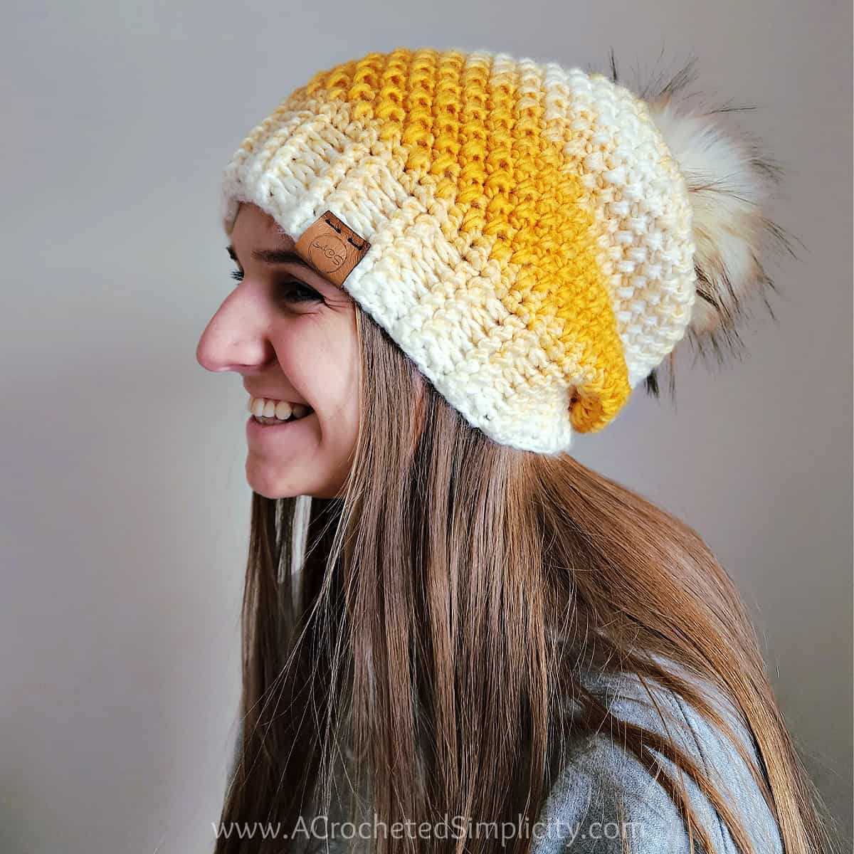 Young girl modeling a women's crochet hat pattern. Scarfie yarn Bulky Crochet Hat Pattern Free.