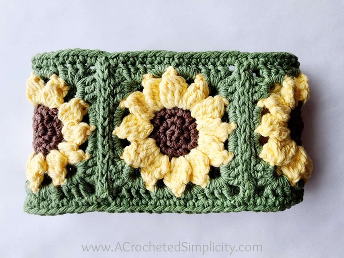 Three sunflower crochet motifs joined to form a loop for the hanging towel.