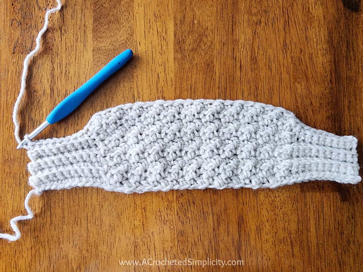 Small crochet swatch of a sweater scarf.