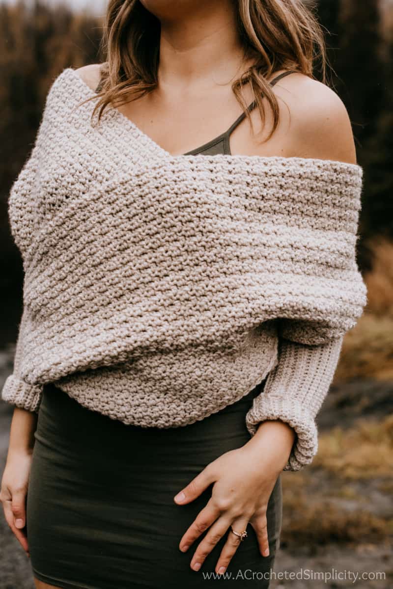 Close-up of a woman wearing a homemade sweater scarf styled as a sweater wrap.