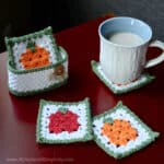 Fall crochet coaster set with holder sitting on red table