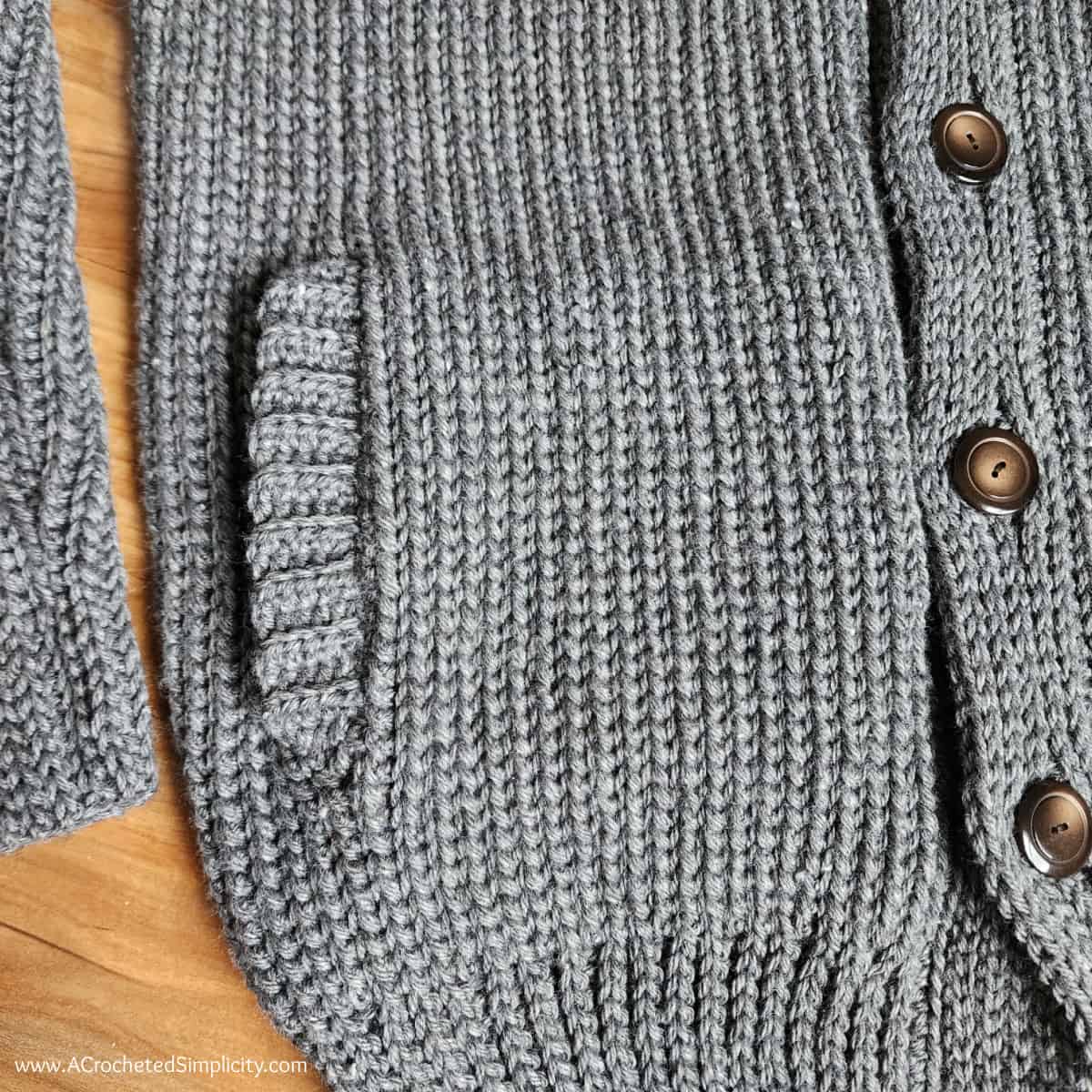 Close up photo of the pocket details on shawl collar cardigan sweater
