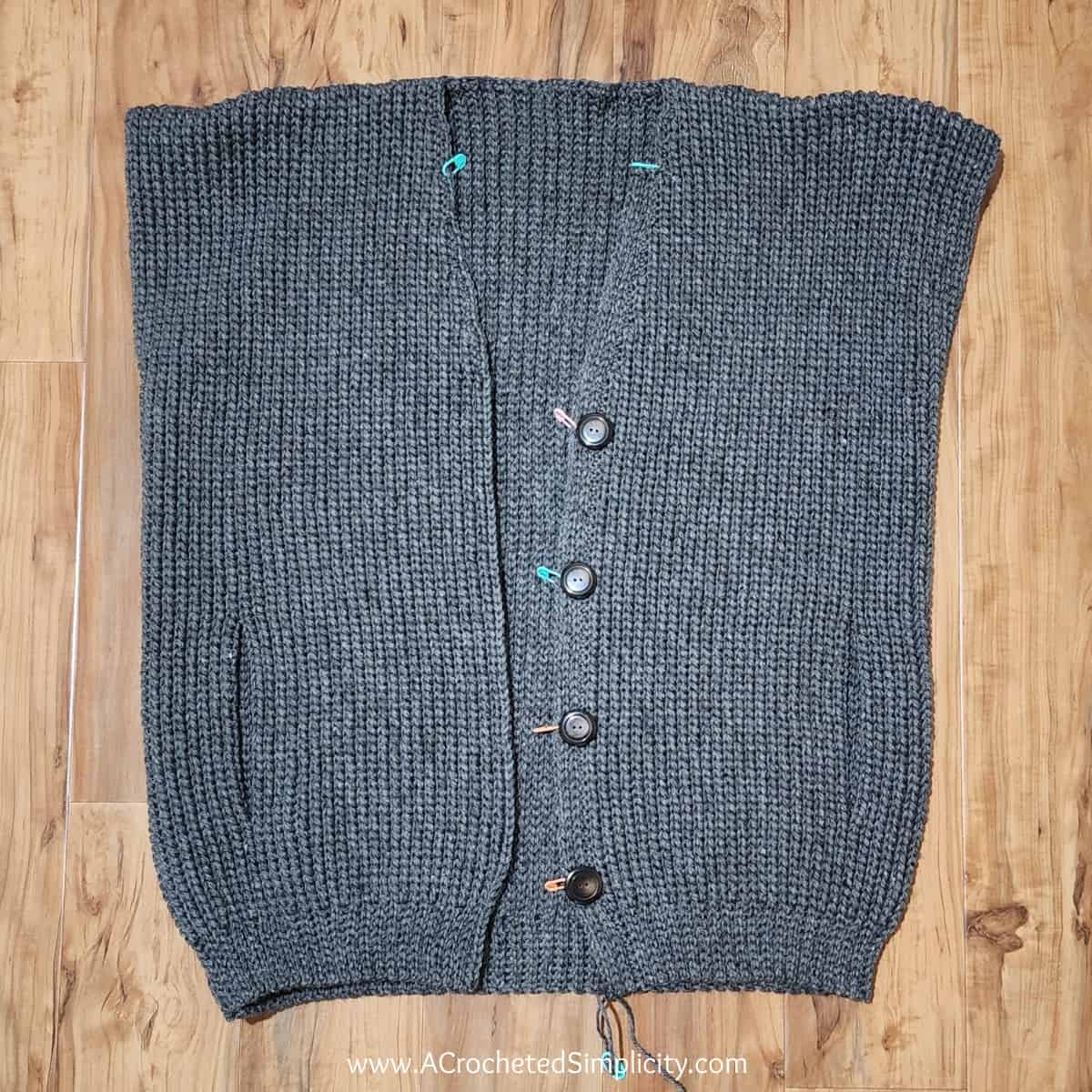 Photo shows placing buttons on mens sweater