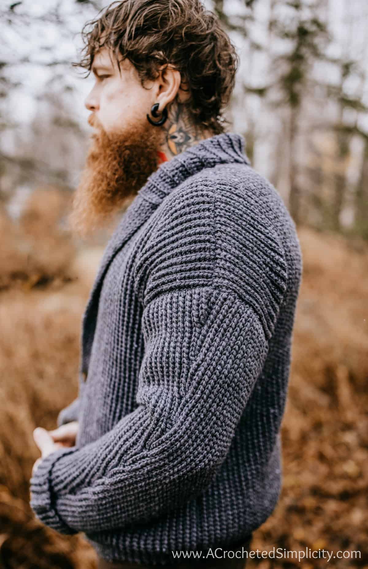 Model slowing sleeve detail on a shawl collar crochet cardigan