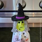 Close up of crochet witch towel ring holder holding halloween hand towel