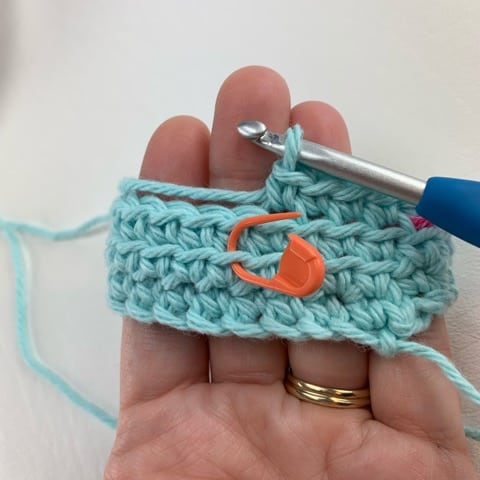 photo tutorial showing the front loop of a stitch two rounds below