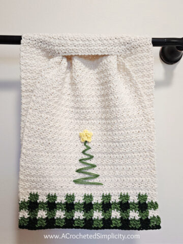 Christmas tree crochet hand towel with buffalo plaid hanging on towel bar