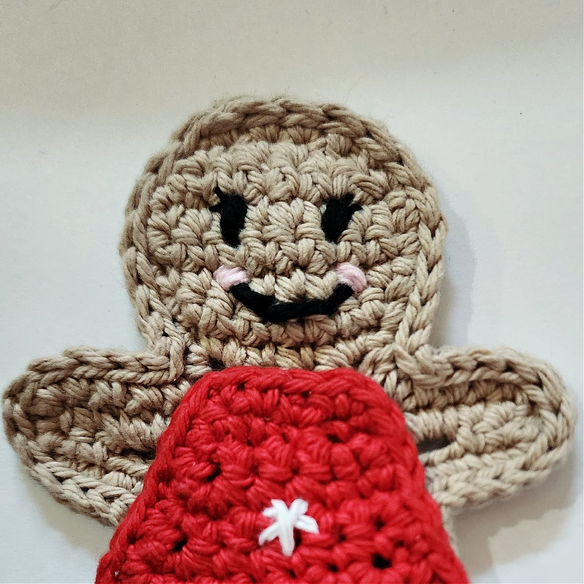 close up of gingerbread girl crochet facial features