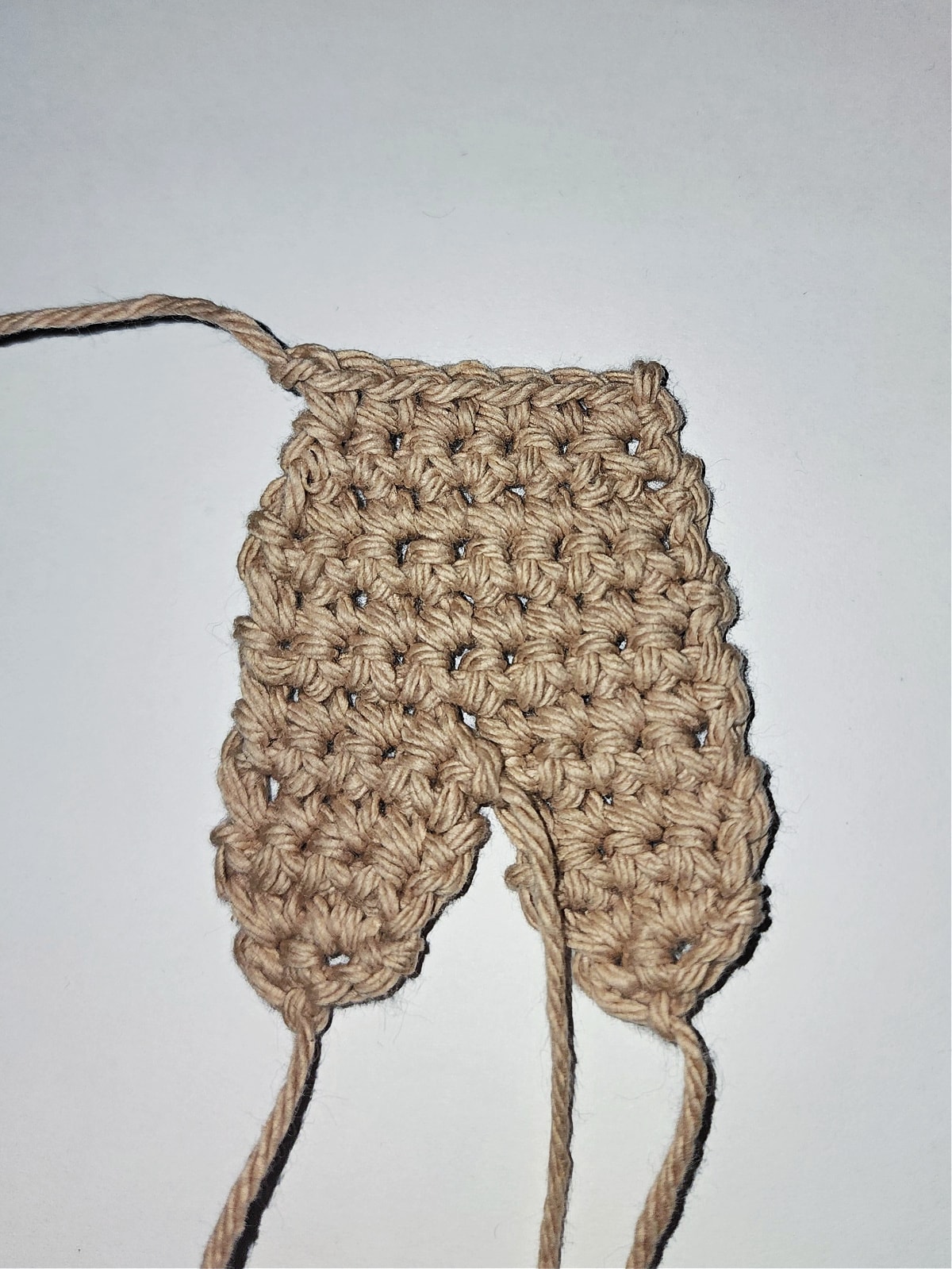 tutorial photo showing crochet gingerbread man legs and body