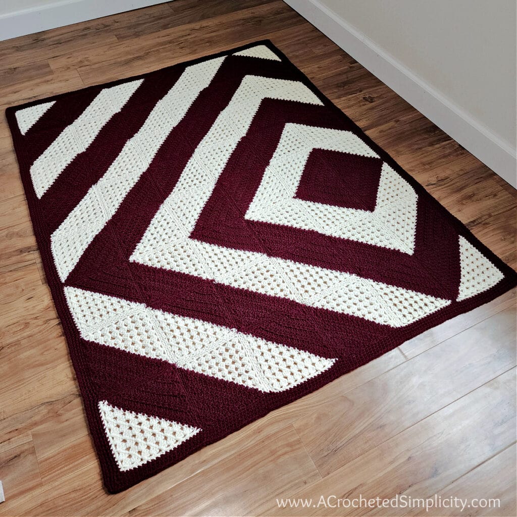 modern c2c crochet quilt laying on wood floor