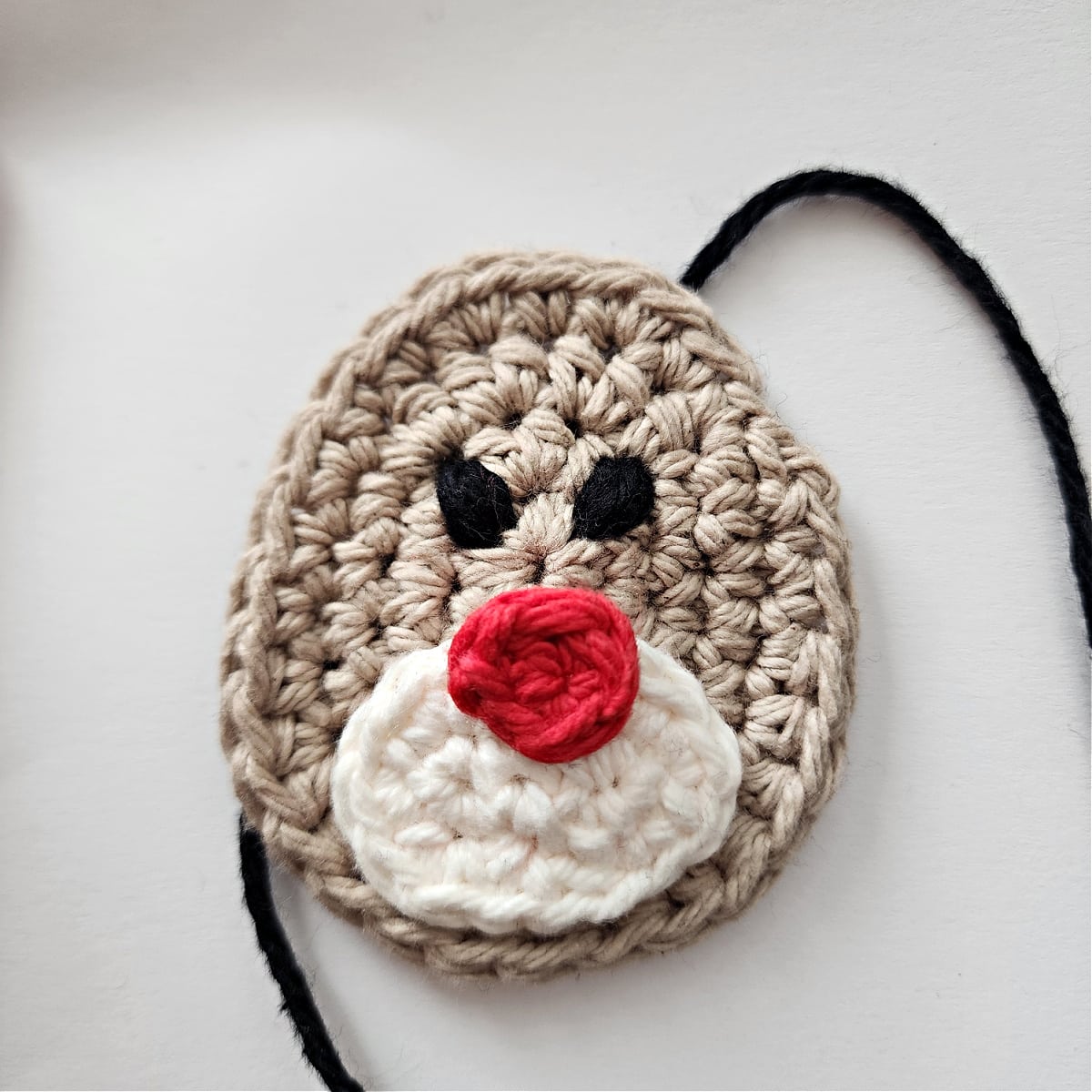 Crochet reindeer embroidered eyes complete.