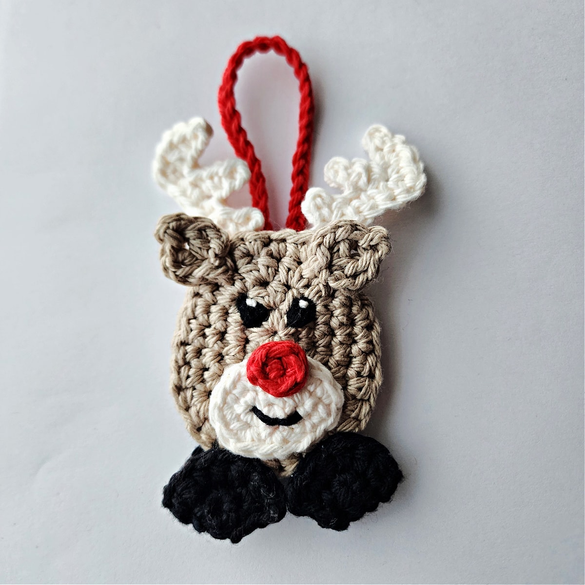 completed crochet reindeer candy cane holder ornament with hanging loop