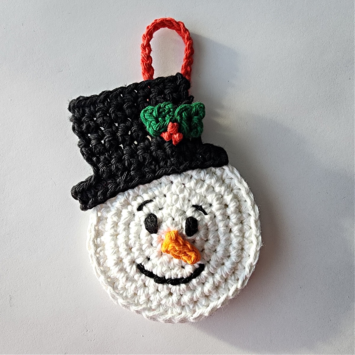 crochet top hat sewn on snowman ornament