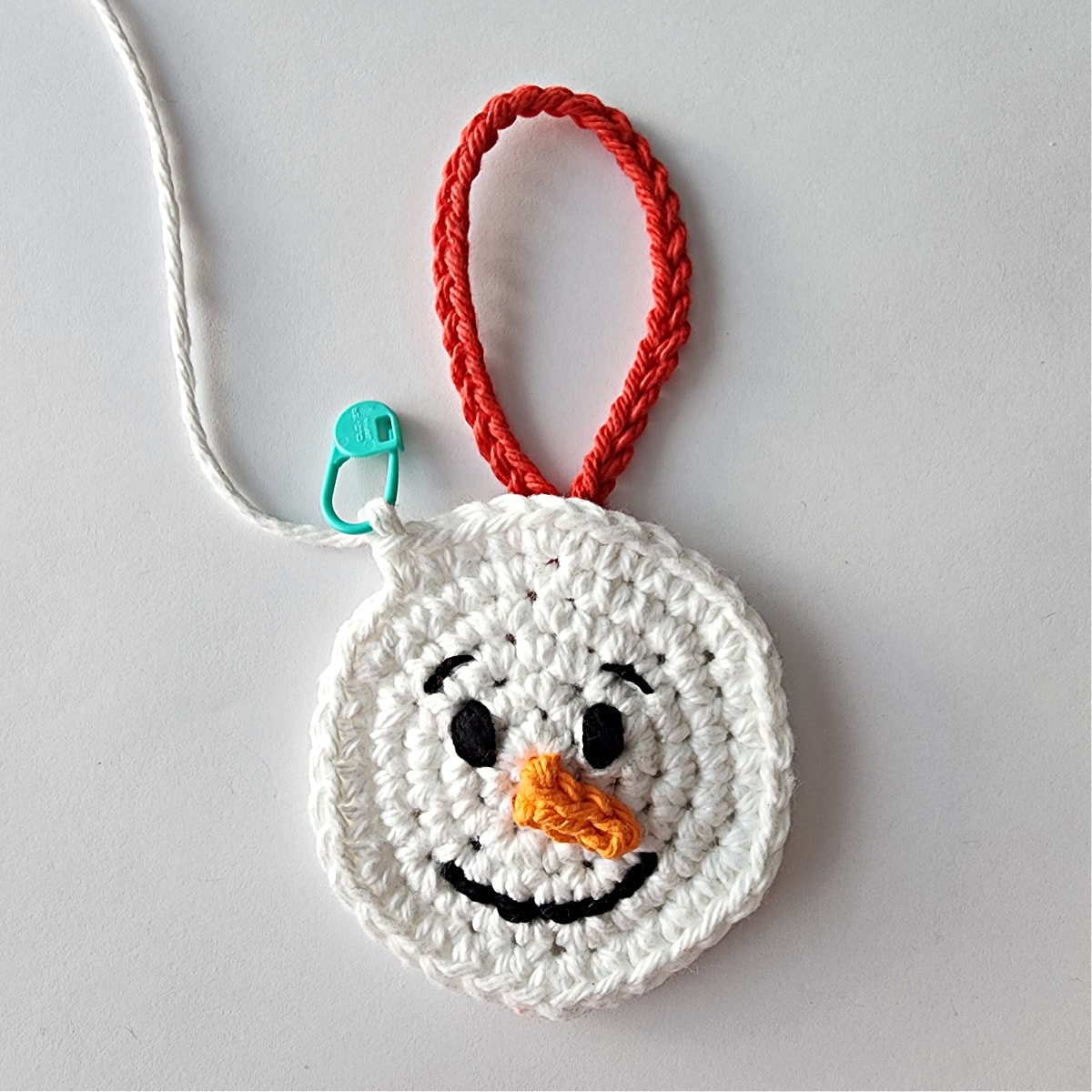 crochet snowman ornament being joined with two layers
