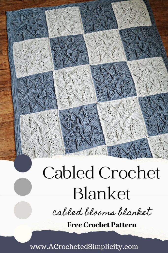 Steel blue and light grey crochet quilt laying on wood floor.