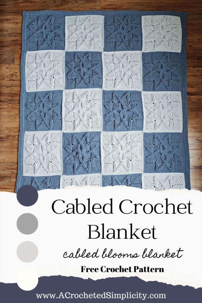 Steel blue and light grey cabled crochet blanket laid on wooden floor.