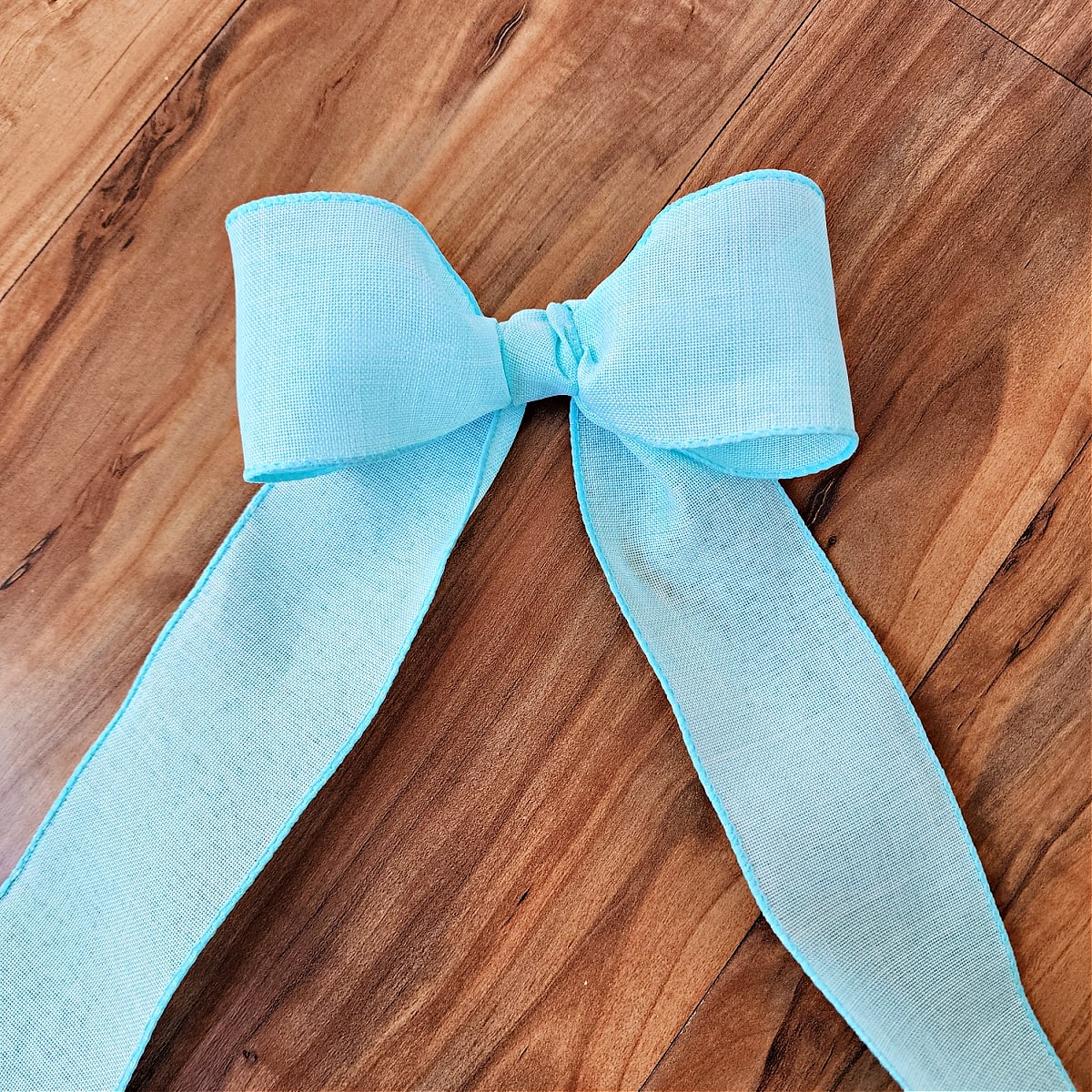 Light blue 2.5" wide dollar tree ribbon bow.