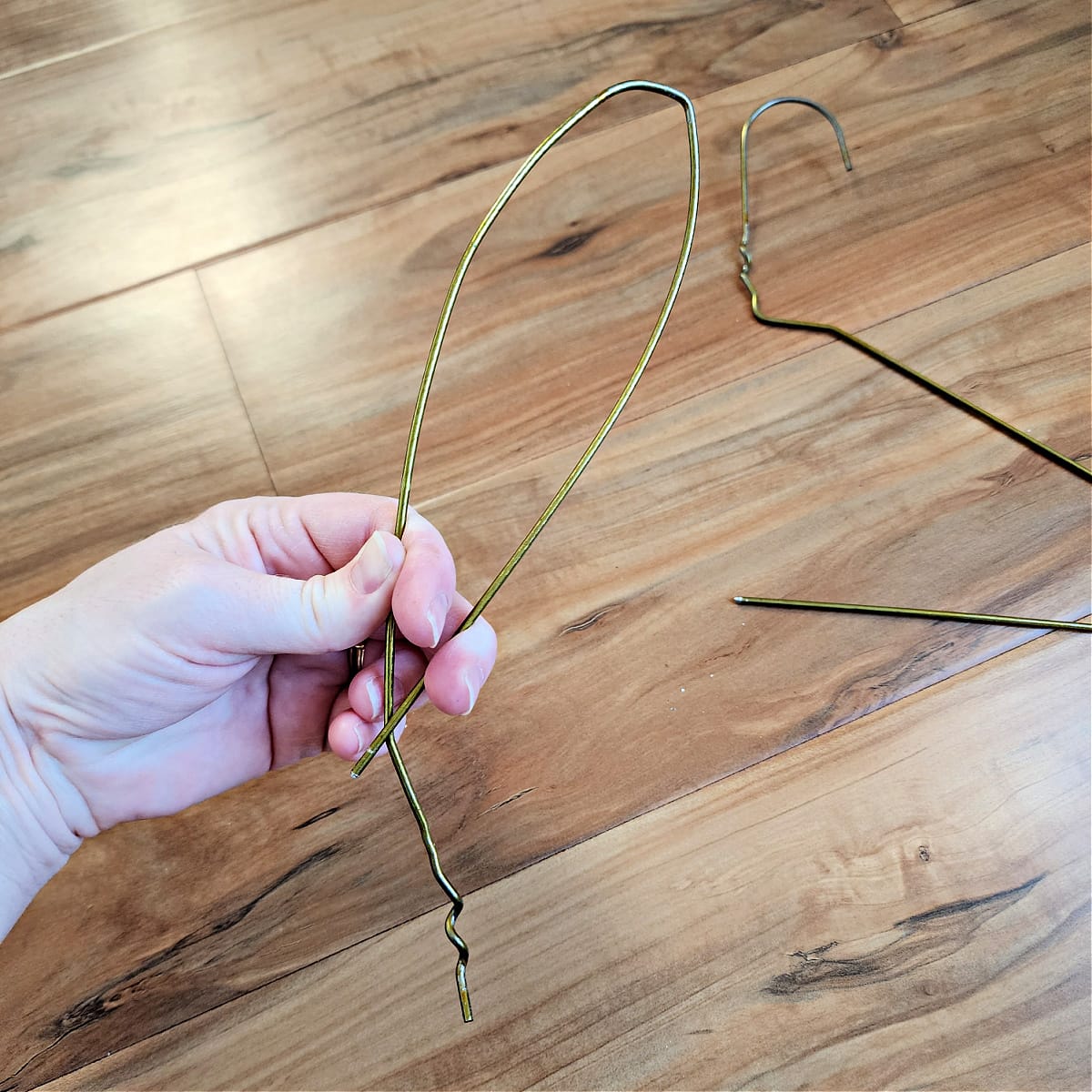 Coat hanger being shaped into a bunny ear.