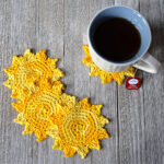 Sun shaped crochet coasters stacked together.