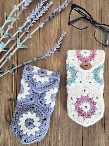 Spring colored crochet eyeglass cases laying with purple glasses and lavender.